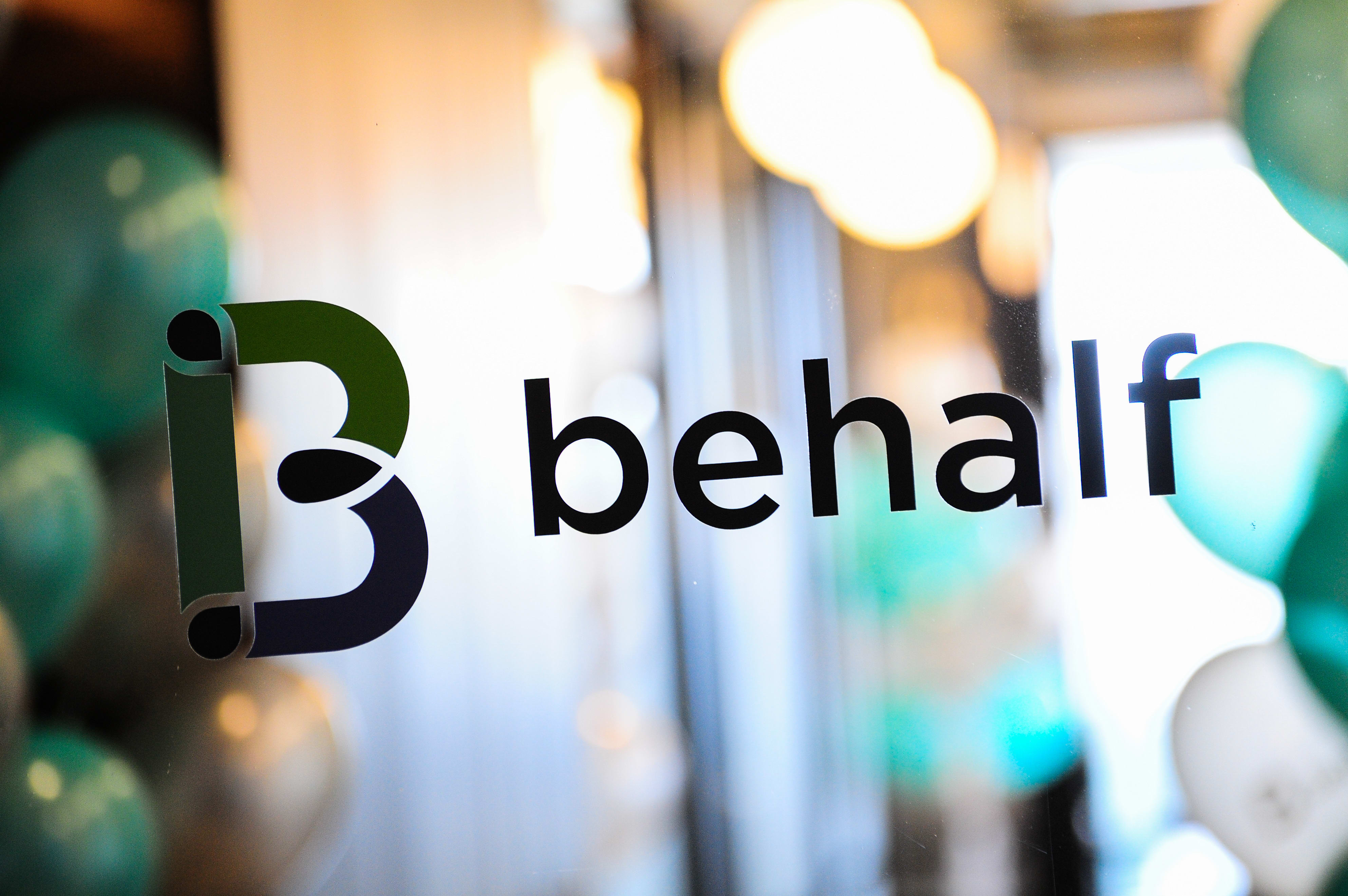 Behalf logo printed on a window